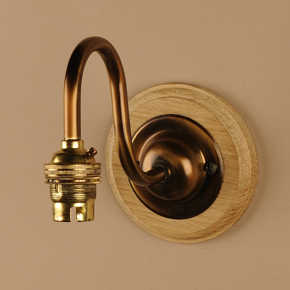 Single Wall Light Bracket in Antiqued Brass